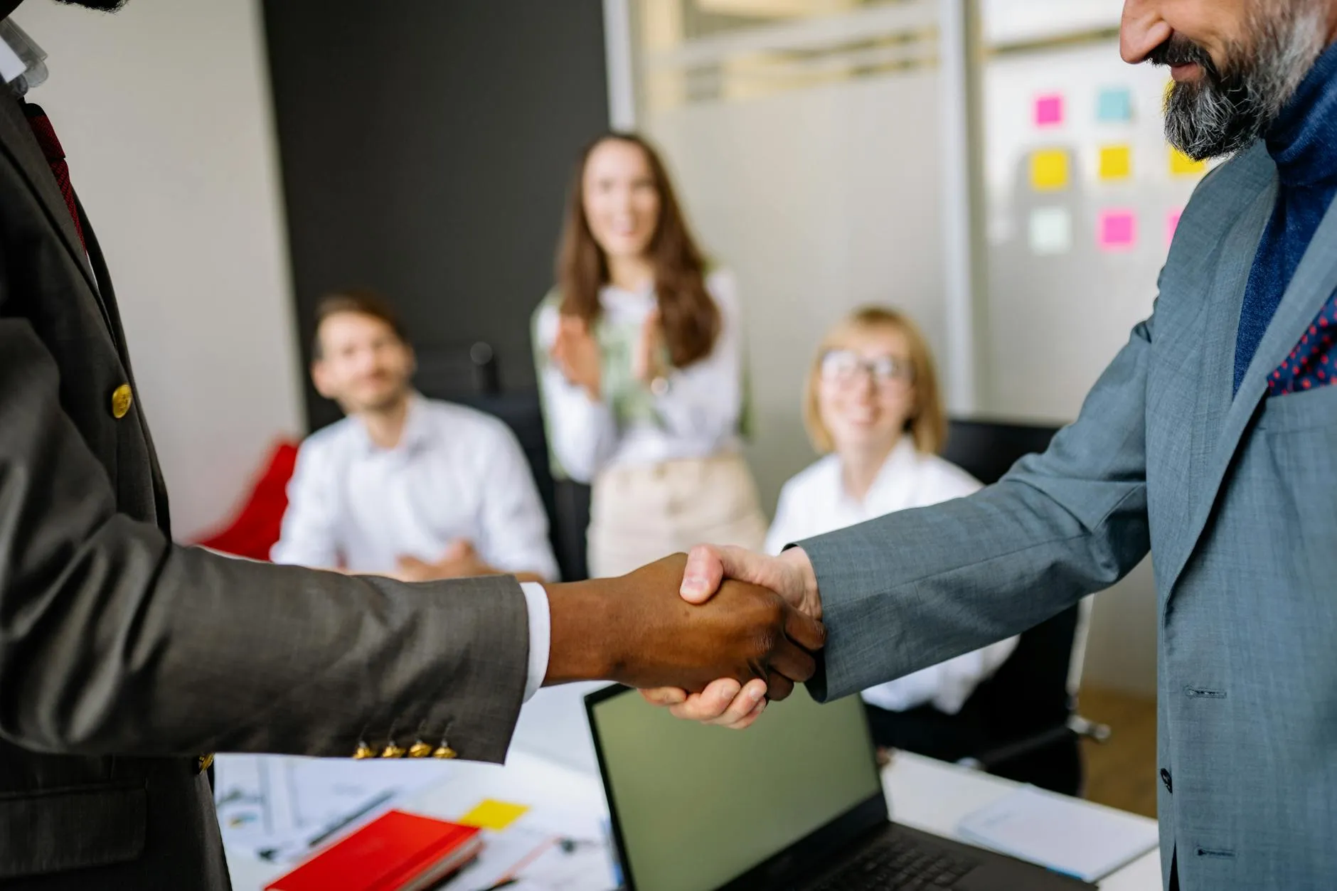 An advisor and clients reviewing a real-estate transaction
