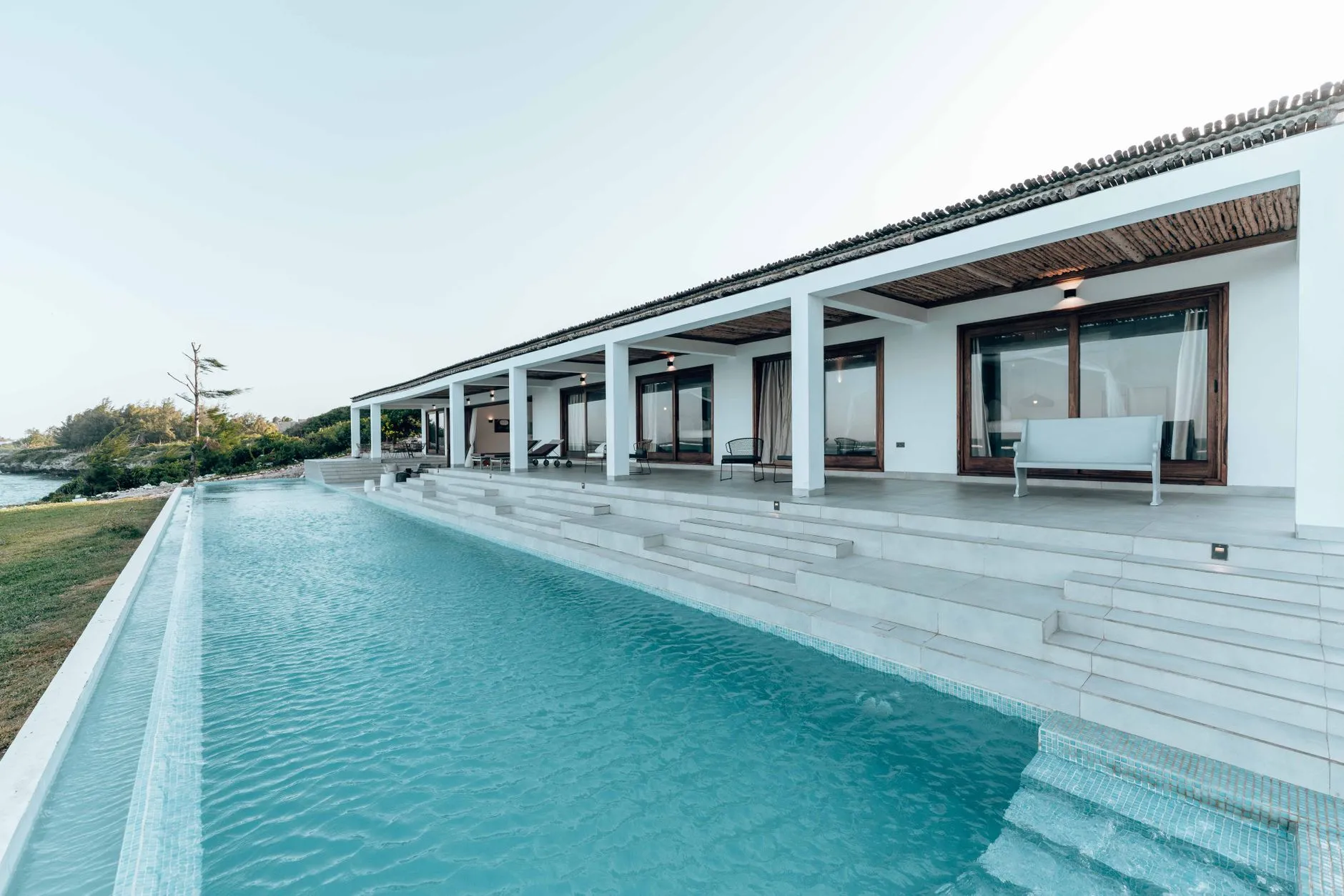 A modern luxury villa with a long infinity pool overlooking the Caribbean in the Riviera Maya