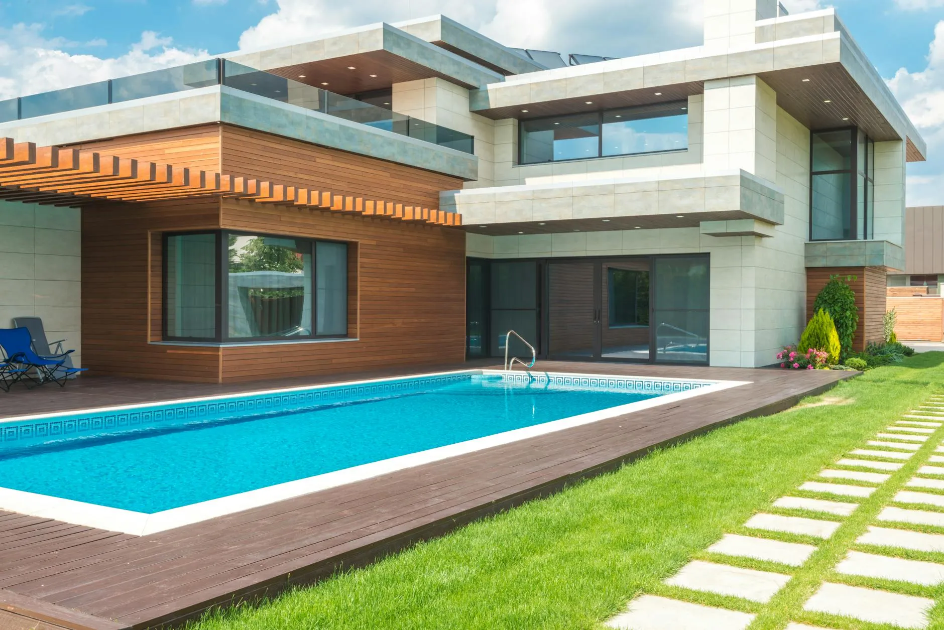 A contemporary luxury villa with a pool and floor-to-ceiling glass